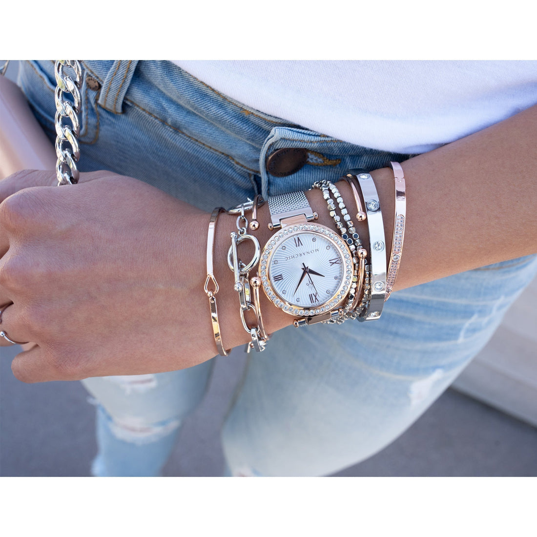 Layered bracelets and women's watch styling example.  Minimalist watch layered with bracelets for everyday elegance.