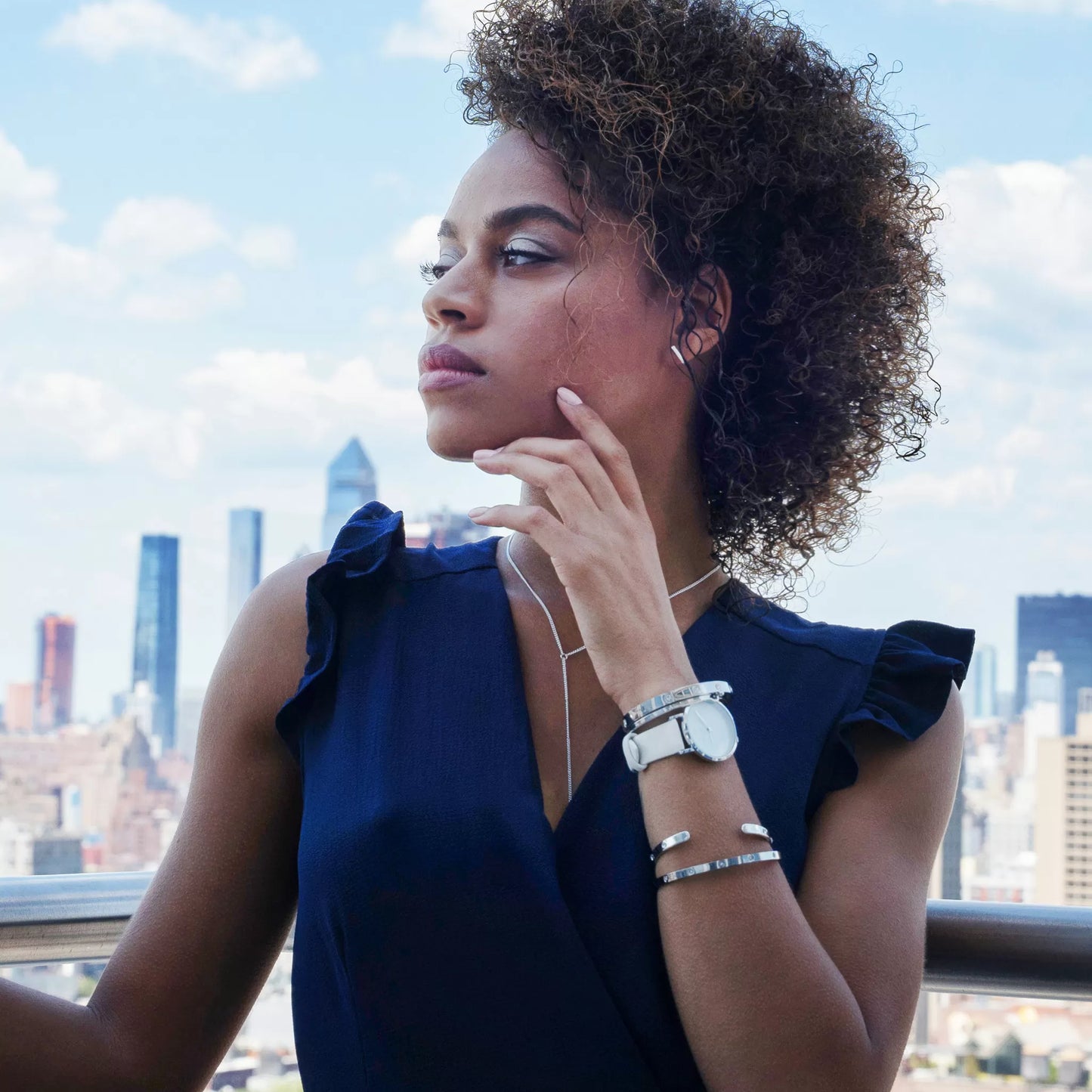 Monarchic® Watch - Model wearing Hillary B - White eco vegan leather straps and silver watch with pearl dial and city view background