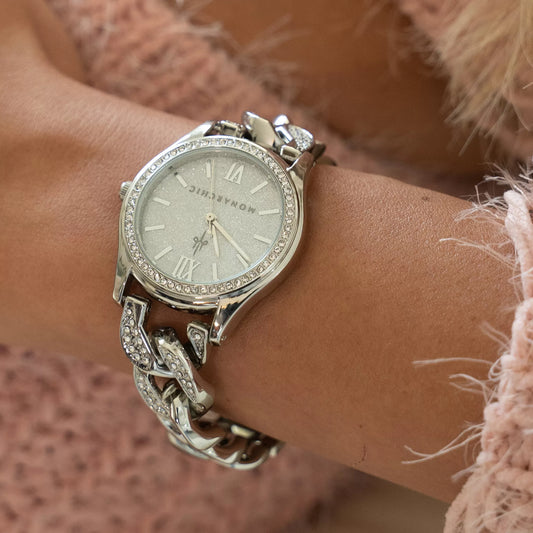 Close-up of the Monarchic® Jennifer silver crystal chain watch worn with a pink knit outfit.