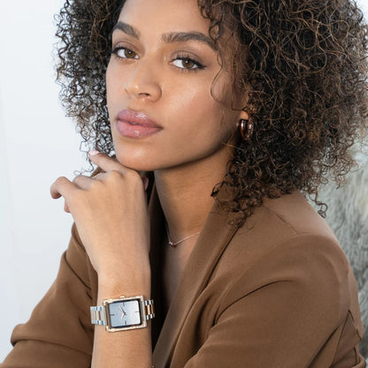 Portrait of a model styling the Monarchic® Diana Dusk watch with a brown blazer.