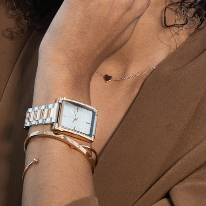 Angled close-up of the Monarchic® Diana Dusk two-tone watch styled with rose gold bracelets.